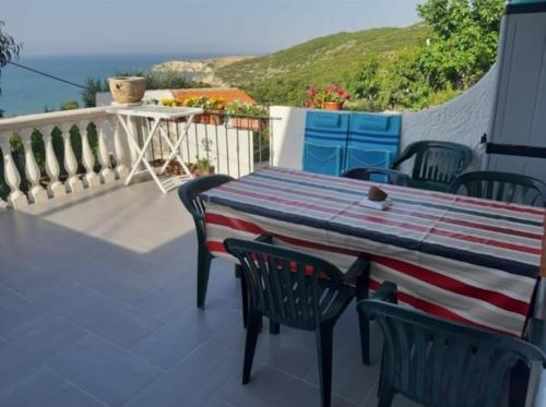 a table and chairs on a balcony with a view of the ocean at Perla Marina in San Nicola