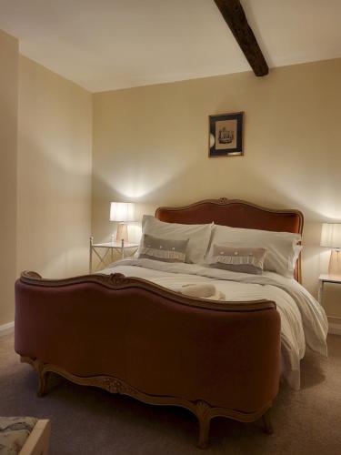 a bedroom with a large bed with a wooden headboard at York Minster Garden in York