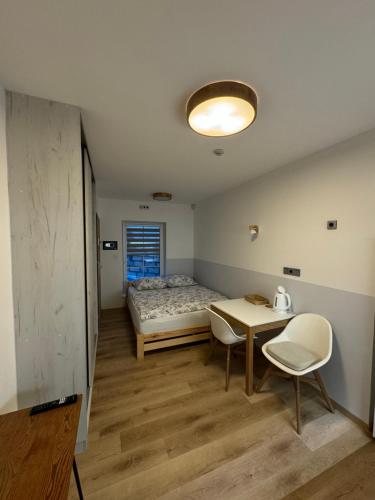 A bed or beds in a room at Penzion pod Kapličkou