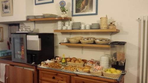 B&B Rendena Chalet في Strembo: مطبخ به طاولة عليها سلال طعام