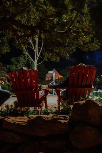 two red chairs sitting next to each other at Zion Glamping Adventures in Hildale