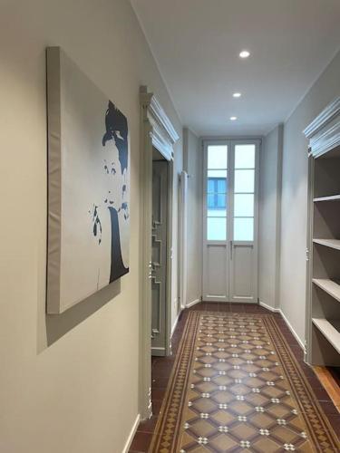 a hallway with a door and a painting on the wall at Appartamento Moon and Stars 7 in Muralto