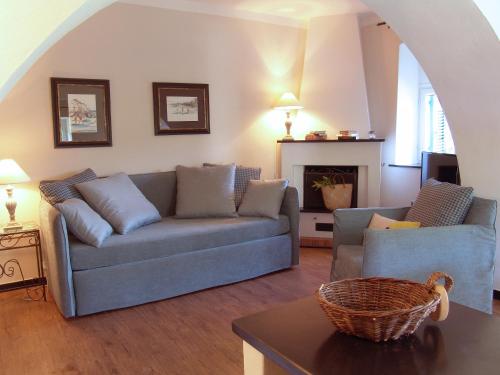 a living room with a couch and a fireplace at Villanova Apartments - Nature & Wellness in Levanto