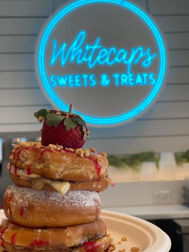 a stack of doughnuts with a strawberry on top at SpringHill Suites by Marriott Navarre Beach in Navarre