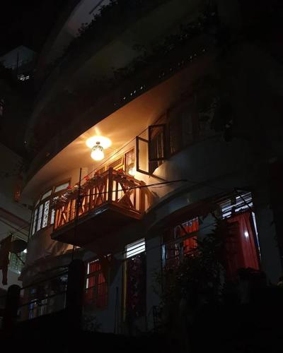a building with a balcony on the side of it at night at BaalaChhen Urban Home Stay in Gangtok