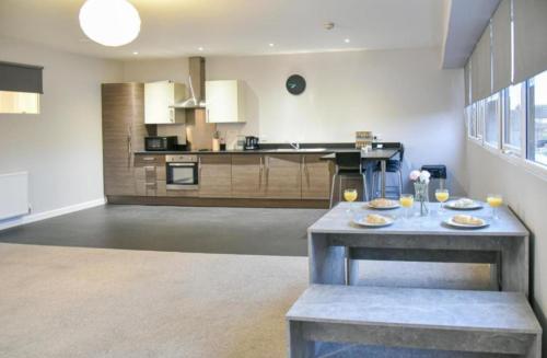 a large kitchen with a table in a room at St Edmunds House in Ipswich