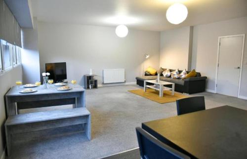 a living room with a couch and a table at St Edmunds House in Ipswich