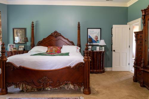 a bedroom with a large bed and blue walls at Exquisite Victorian in Springfield