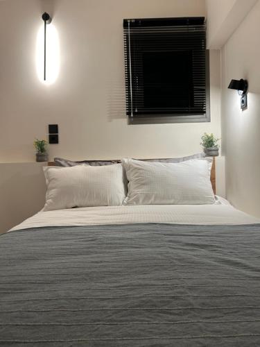 a bedroom with a large white bed with a window at Hilltop house in Ioannina