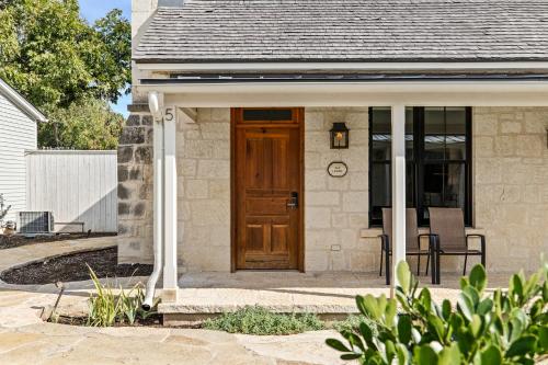 a home with a wooden door and a porch at Blacksmith Quarters in Fredericksburg
