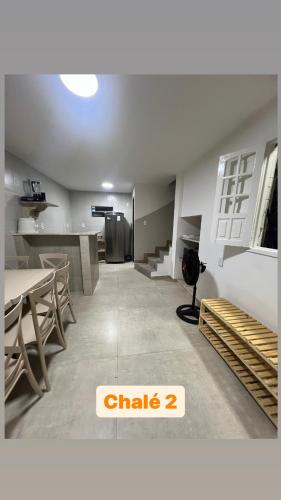 a dining room with a table and chairs in a room at Village Galés de Maragogi in Maragogi