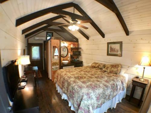 a bedroom with a large bed and two lamps at Tiny Home Cottage Near the Smokies #1 Olga in Sevierville