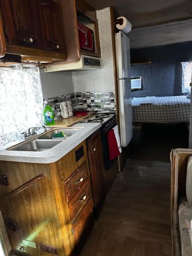 a small kitchen with a sink and a stove at Studio Black Castle RV in Miami