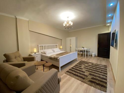 a bedroom with a bed and a living room with a couch at Chelay studios Nasr city in Cairo
