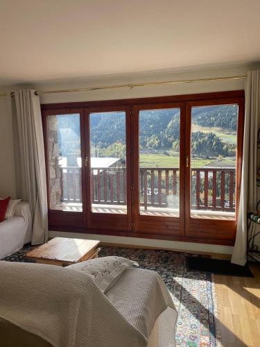 a bedroom with a large window with a view at Chez Maurice avec une belle vue in El Tarter