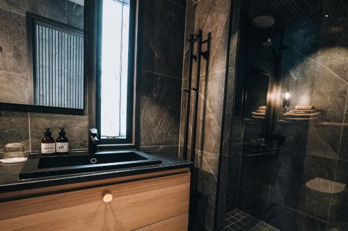 a bathroom with a sink and a shower at Panorama Landscape Hotel in Nilsiä