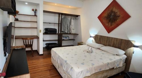 - une petite chambre avec un lit, une table et un bureau dans l'établissement My Home 2 quartos em Cobertura ao lado da praia, à Rio de Janeiro