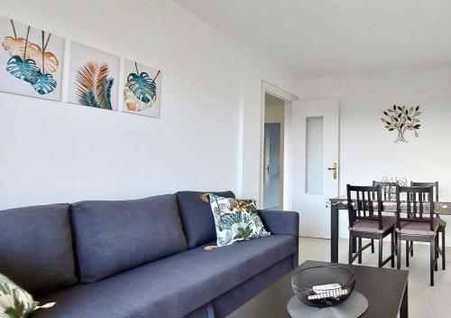 sala de estar con sofá azul y mesa en Éclat Méditerranéen - Côte d'Azur, en Cagnes-sur-Mer