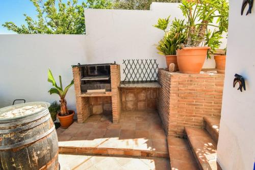 a patio with an outdoor oven with potted plants at Vega’s Love in Málaga