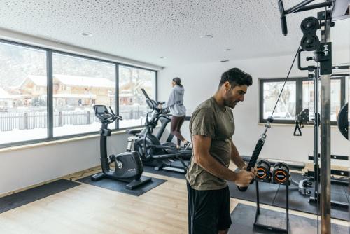 a man exercising in a gym at Feelfree Nature Resort in Oetz