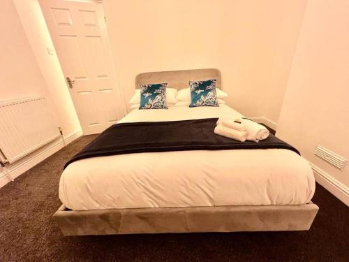 a bed with two pillows on it in a room at SkylinesAirbnb in Stoke on Trent
