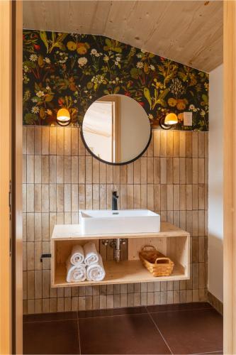 a bathroom with a sink and a mirror at Eastwind Hotel Oliverea Valley in Big Indian