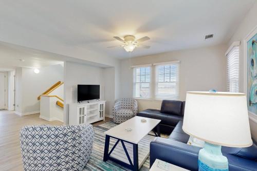 a living room with a couch and a tv at Sailfish in Buxton