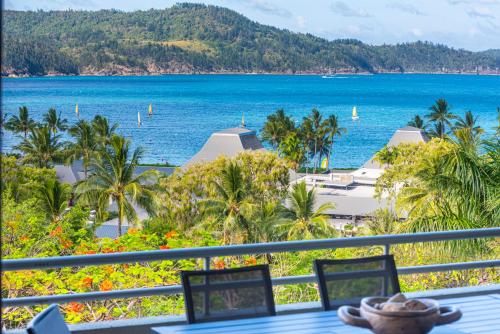 a view of the ocean from the balcony of a resort at Poinciana 109 & Buggy Hamilton Island in Hamilton Island