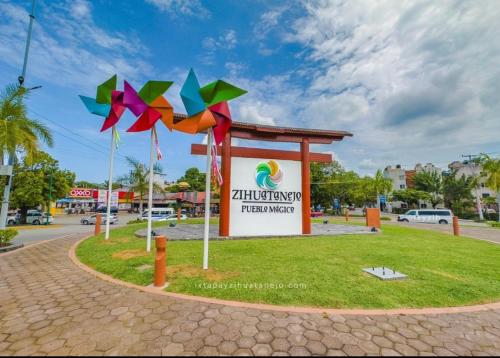 a sign in front of a park with colorful kites at Hotel Familiar El Dorado in Zihuatanejo