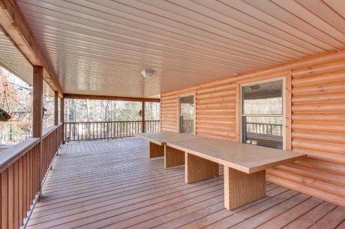 a wooden porch with a wooden bench on a deck at Hiawassee Vacation Rental with Grill about 9 Mi to Lake! in Hiawassee