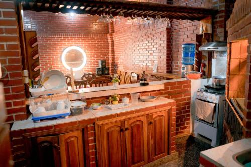 a kitchen with a sink and a brick wall at Country house, friends, meetings, well connected in Luque
