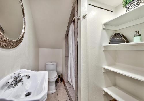 a white bathroom with a sink and a toilet at Private beach, Close to ski, Resort Amenities! in South Lake Tahoe