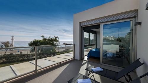 a balcony with a view of the ocean at PARADISE beachfront luxury villa in Villajoyosa