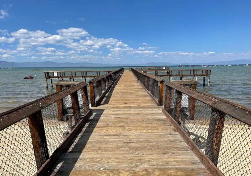 a wooden pier stretches out into the water at Private beach, Close to ski, Resort Amenities! in South Lake Tahoe