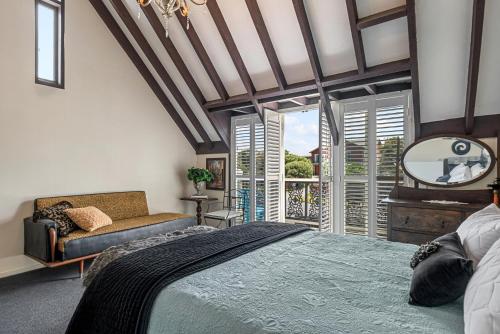 a bedroom with a bed and a mirror and a window at Tutere Treasure - Waikanae Holiday Home in Waikanae