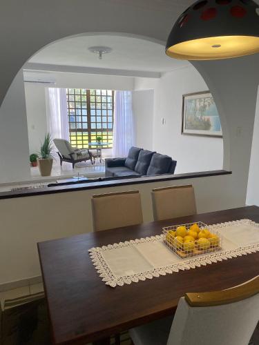 a dining room table with a bowl of oranges on it at RCM Vilas - Casa Confortável 02 in Joinville