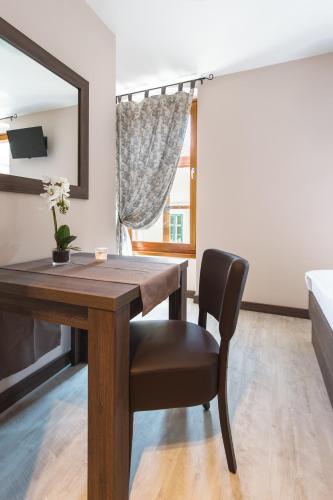 a dining room with a table and a mirror at Hotel Pri mostu in Dolenjske Toplice
