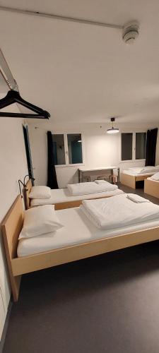 a room with four large beds in it at Bogentrakt in Chur