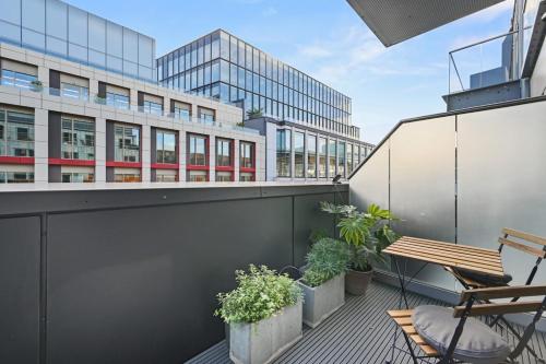 a balcony with a bench and plants on a building at Sleek 2BD Flat wTerrace - 2 Mins from Farringdon! in London