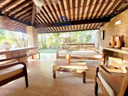 a room with two beds and a table with vases on it at Itacimirim Villas da Praia in Camacari