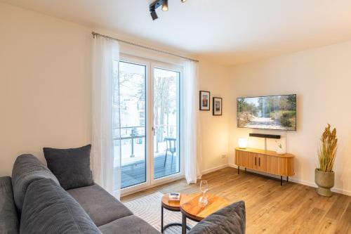 a living room with a couch and a large window at Apartment "Haff Ahoi" - Haffresidenz in Garz-Usedom