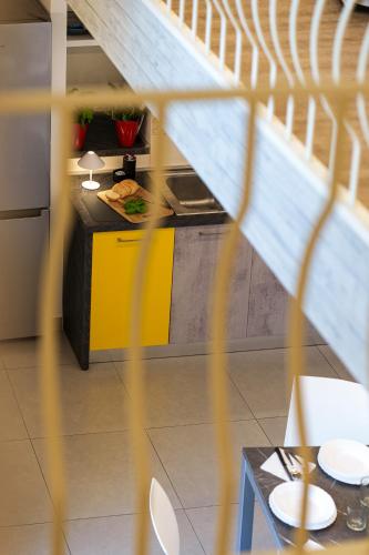 a kitchen with a yellow counter and a table at Holidays Homes The dream in Sant'Agnello