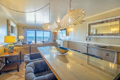 a living room with a table and a couch at The Colony at Virginia Beach by TripForth in Virginia Beach