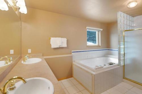 a bathroom with a tub and a sink at Fawn Court - Wildernest in Silverthorne