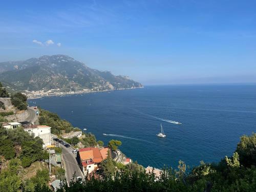 a sailboat in the ocean with a boat on the water at Ravello suite in Ravello