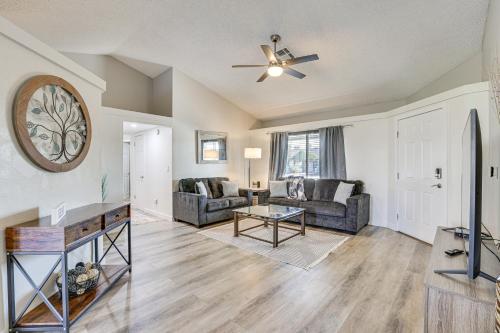 a living room with a couch and a table at Peoria Home with Private Pool, Hot Tub, and Gas Grill! in Peoria