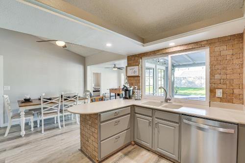 a kitchen and dining room with a large window at Peoria Home with Private Pool, Hot Tub, and Gas Grill! in Peoria