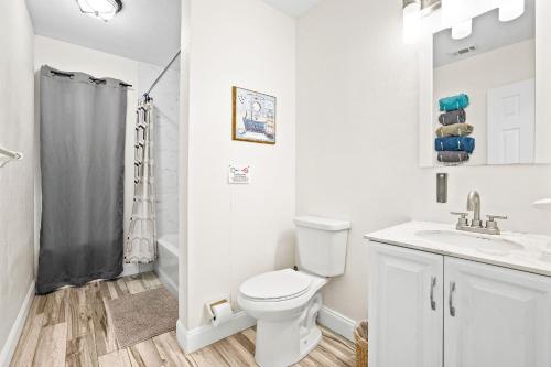 a white bathroom with a toilet and a sink at Bayshore Home in Tampa