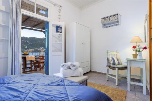 1 dormitorio con 1 cama, 1 silla y 1 mesa en villa Yiannoula, en Skopelos Town