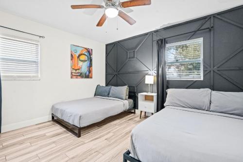 a bedroom with two beds and a ceiling fan at Bayshore Home in Tampa